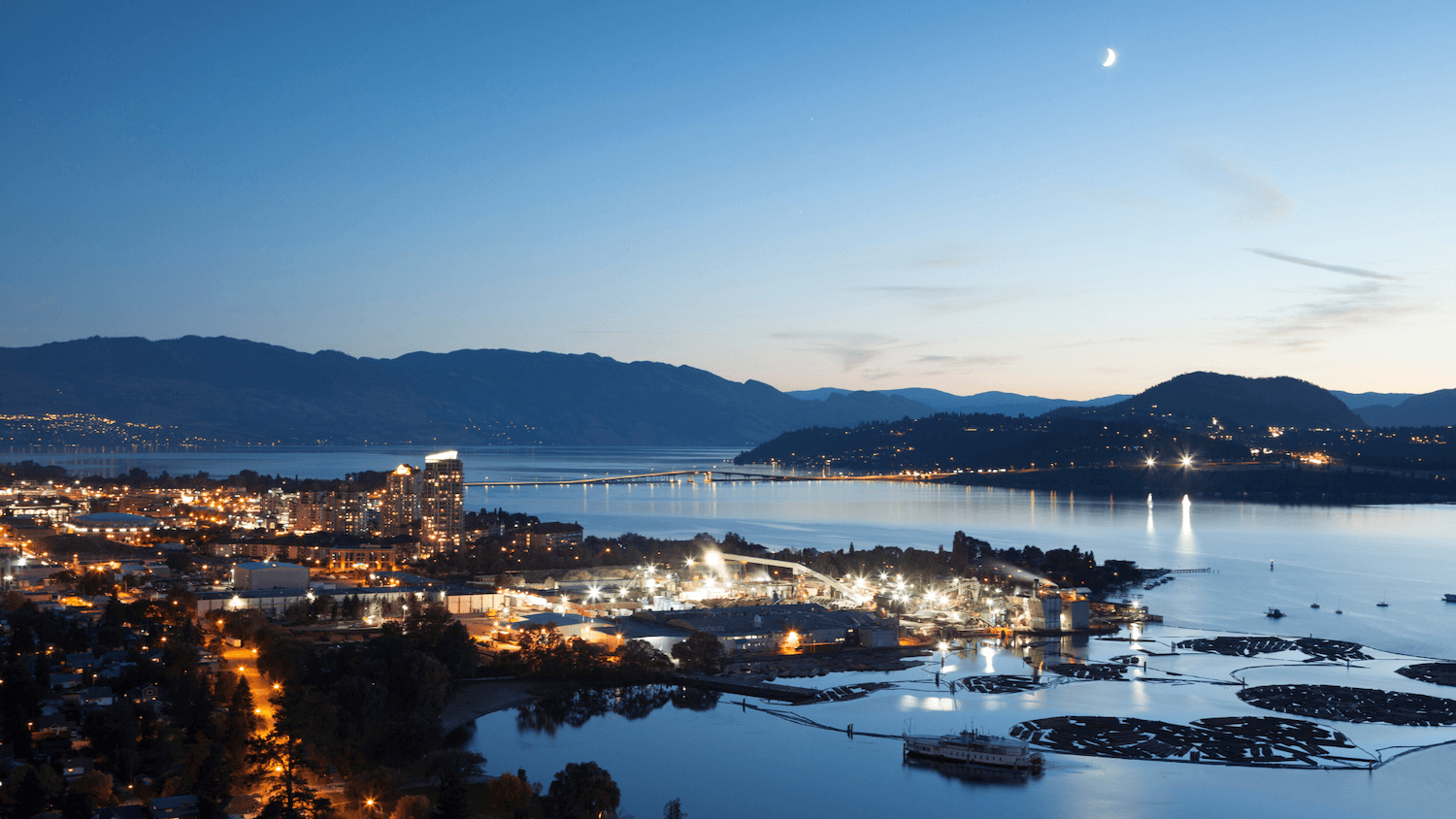 Kelowna and Okanagan Lake at dusk, seen from the hills above the city