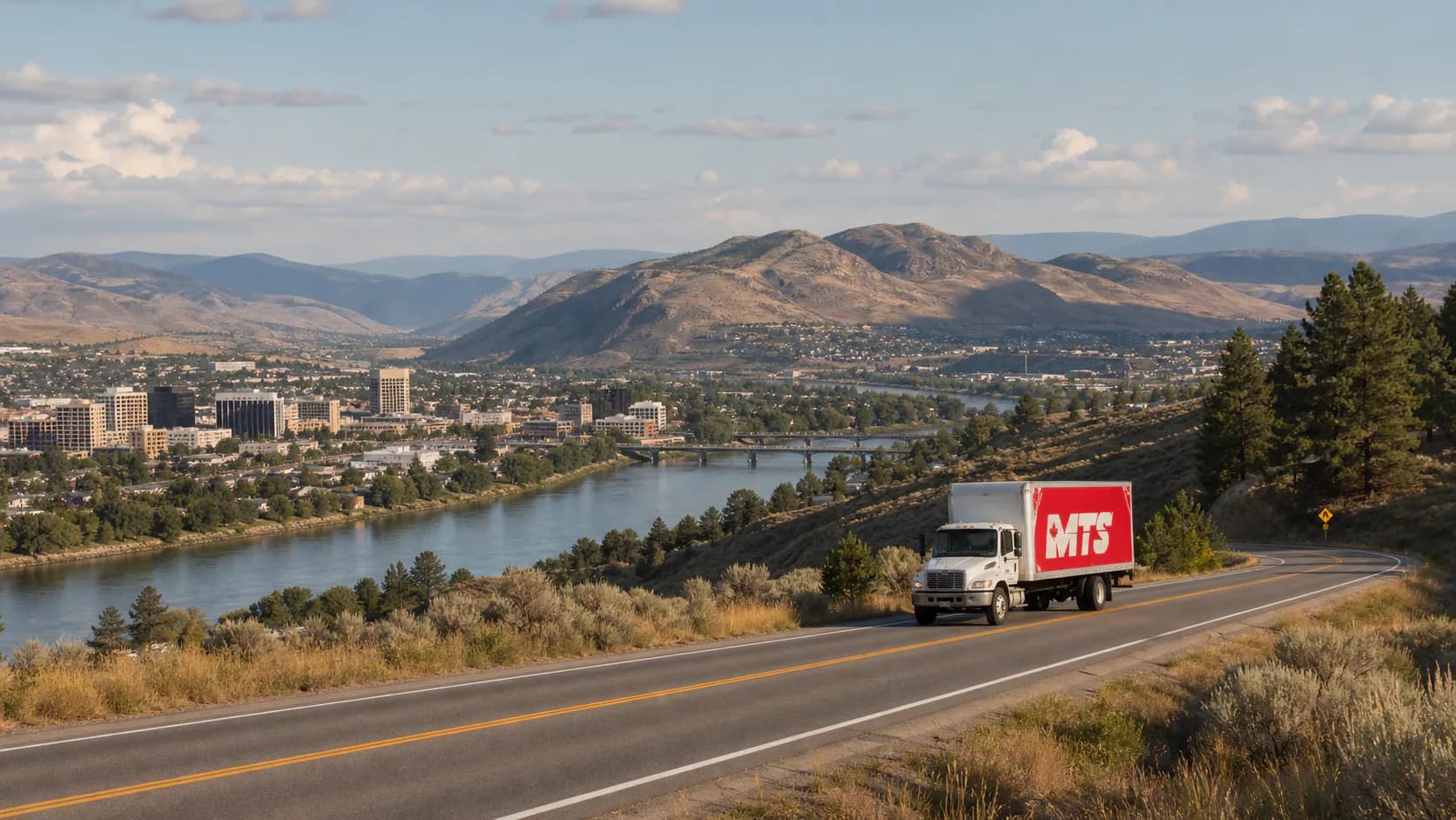 An MTS moving truck approaching Kamloops through the dry Thompson River valley